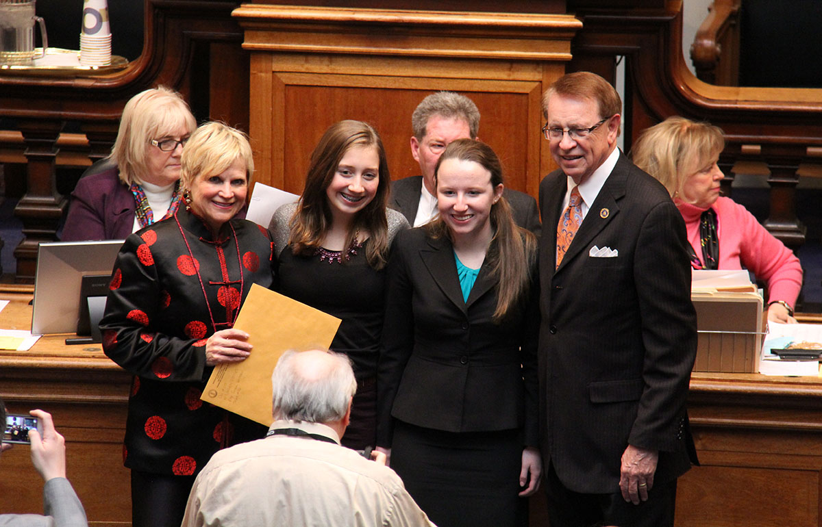 Rep. Susan Westrom of Lexington (from left), 2012 KAGE Distinguished Student Kasey Fields, Gatton Academy senior Julia Gensheimer and Rep. Jody Richards of Bowling Green pose for a picture in the House Chambers after the students were recognized by the House of Representatives.
