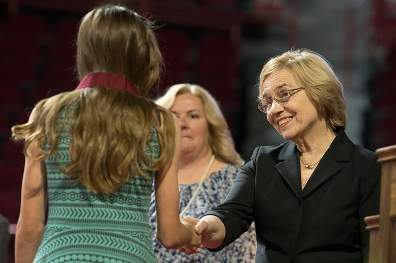 Julia Roberts, executive director of The Center for Gifted Studies, greets students after they receive medals.