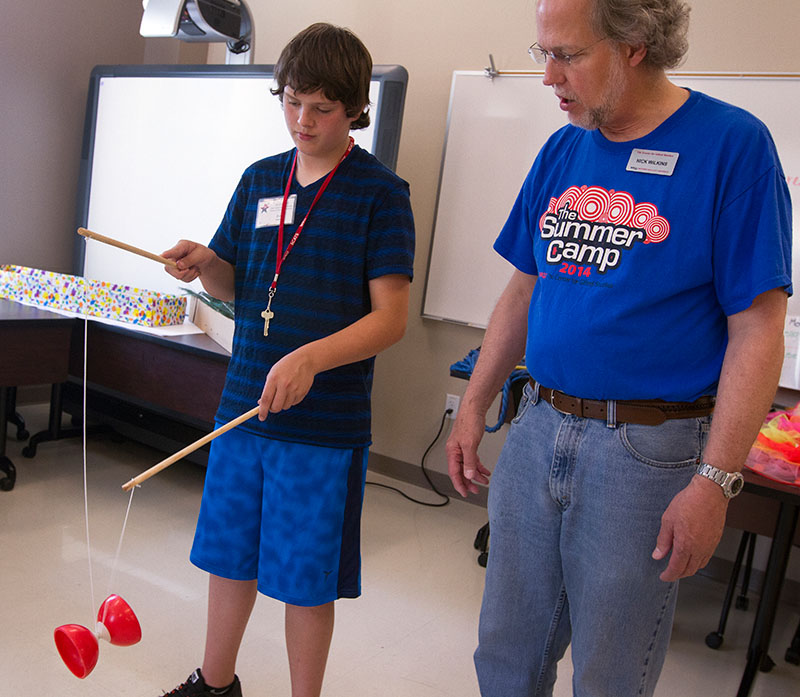 Zach Hanvey from Paris receives instructions from Clowning teacher Nick Wilkins on using the diabolo, a Chinese yo-yo, Wednesday, June 10.  Zach is taking Clowning for the second year. (Photo by Sam Oldenburg)