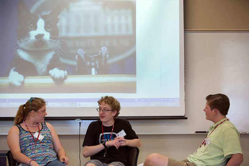 Emma Latherow (from left) of Ashland, Lij Brazel of Louisville and Erik Bishop of Baxter, Tenn., give an improv presentation during Public Speaking June 11. The group was given a random picture then had to come up with a presentation about it on the spot. (Photo by Emilie Milcarek)
