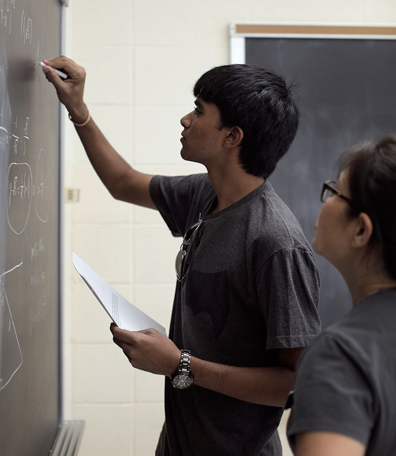 Karthik Boyareddygari works out a problem on the board as a demonstration during Math on Wednesday, June 24. (Photo by Emilie Milcarek)