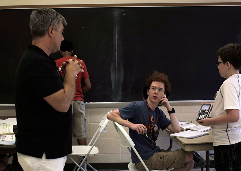 Ethan Abate of Florence has a friendly debate over a question with teacher Bruce Kessler in Mathematics on Wednesday, June 24. (Photo by Emilie Milcarek)