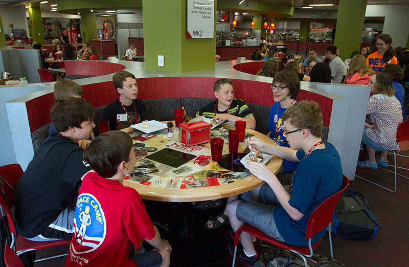 Campers from counselor Jake Inman's group eat breakfast together in Fresh Foods Tuesday. (Photo by Sam Oldenburg)