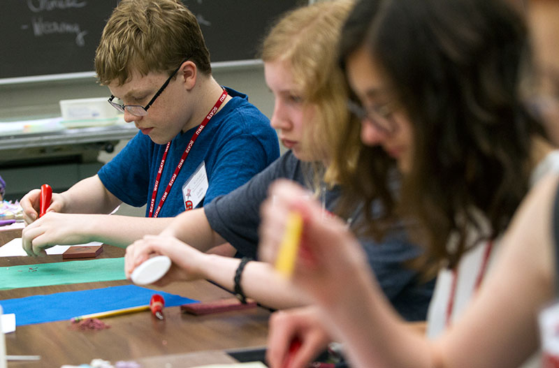 Griffin Salsman of Springfield, Tenn., works on a project during Mixed Media Multicultural Art Experience Tuesday. Students created rubber stamps that they would use to stamp a pattern on fabric in order to make Japanese Carps. (Photo by Sam Oldenburg)