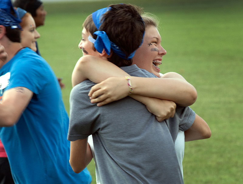 Olivia Gilliam of Madisonville hugs her teammate, Baxter Fee of Bowling Green, in excitement after winning the relay race for Team Open Waters for the VAMPY Olympics on Saturday, June 27. (Photo by Emilie Milcarek)