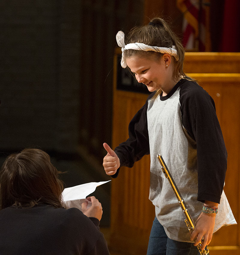 Audrey Thacker of Louisville gives a thumbs-up to head counselor Taylor Koczot before performing "Fanfare and Fireworks" on her flute during the SCATS Talent Show Wednesday, June 17. (Photo by Sam Oldenburg)