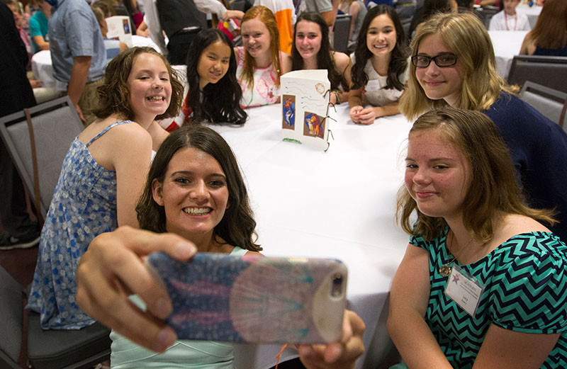Counselor Kayce Hyde talks a selfie with her campers before the SCATS Banquet Thursday, June 18. (Photo by Sam Oldenburg)