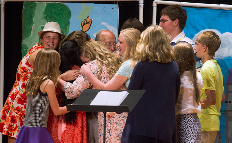 Musical Troupe students gather around their teacher, Jim Fulkerson, for a group hug after their performance Thursday, June 18. Jim announced that he will retire from teaching SCATS after having taught at SCATS for 27 years. (Photo by Sam Oldenburg)