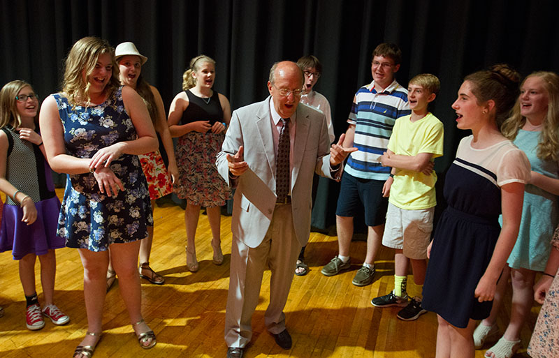 Musical Troupe teacher Jim Fulkerson leads the class in warm ups before their performance following the SCATS Banquet Thursday, June 18. (Photo by Sam Oldenburg)