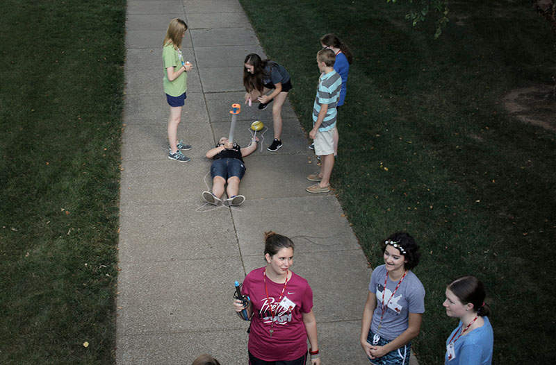 Campers participate in the optional "CSI: Bowling Green" Wednesday, June 24, outside Norhteast Hall. "CSI" stood for "Chalk Scene Investigation," and campers had to build and then explain elaborate murders that were given to them. (Photo by Emilie Milcarek)