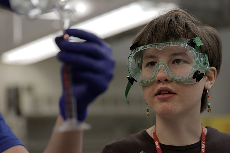 Beth Furry of Stanford, North Carolina, watches as her partner measures the chemicals Tuesday, June 23, in Advanced Investigations in Chemistry. Campers were testing reactions. (Photo by Emilie Milcarek)