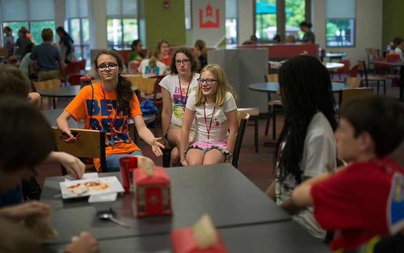 Chloe Paddack (from left) from Falls of Rough, Emma Simpson from Bowling Green and Abby Adams-Smith from Bowling Green talk to a table full of boys during dinner at Fresh Foods Tuesday, June 9. (Photo by Emilie Milcarek)