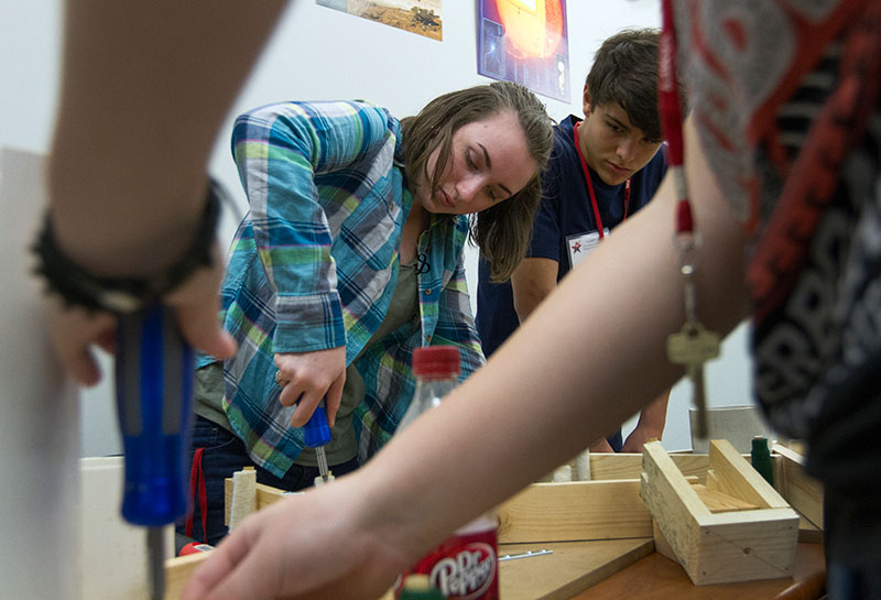 Emily Leamon of Frankfort works on the feet for her telescopr during Astronomy Wednesday, June 24. Students built their own telescopes and will use them to look at the night sky in the coming weeks. (Photo by Sam Oldenburg)