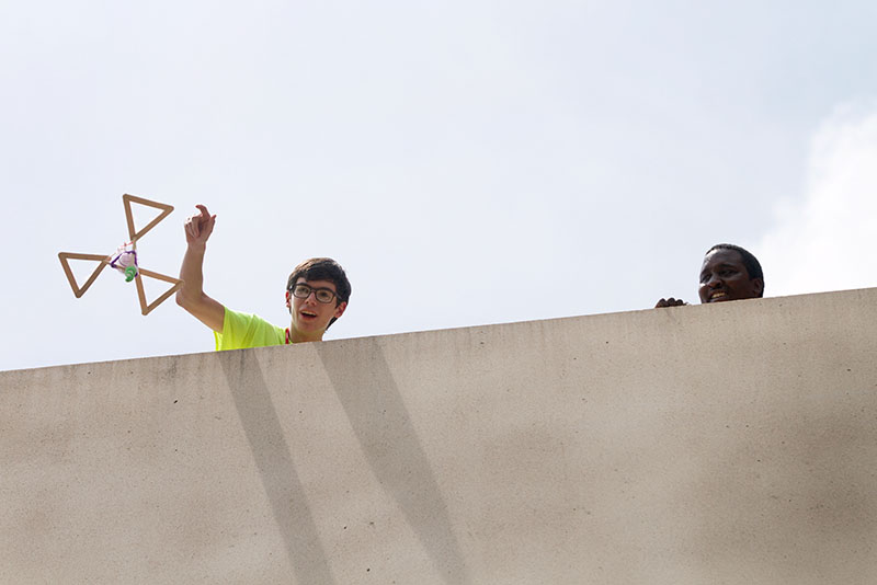 Max Chambers of Benton spins his egg drop container while releasing it from the top of Parking Structure 2 as teaching assistant Joshua Keeling looks on Tuesday, June 23, during Problems You Have Never Solved Before. (Photo by Sam Oldenburg)