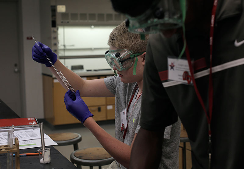 Ben Clements of Morganfield conducts an experiment with his partner to test for chemical reactions in Advanced Investigations in Chemistry Tuesday, June 23. (Photo by Emilie Milcarek)