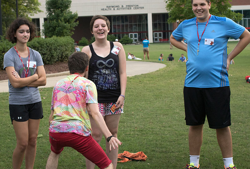 Nathaniel Brantly of Fort Collins, Colorado, tries to make Becca Mikula of Savannah, Missouri, laugh during an ice breaker game while Katarina Vance (left) of Nashville, Tennessee, and Sterling Ortiz (right) of Delray Beach, Florida, laugh along and wait for their turn. (Photo by Emilie Milcarek)