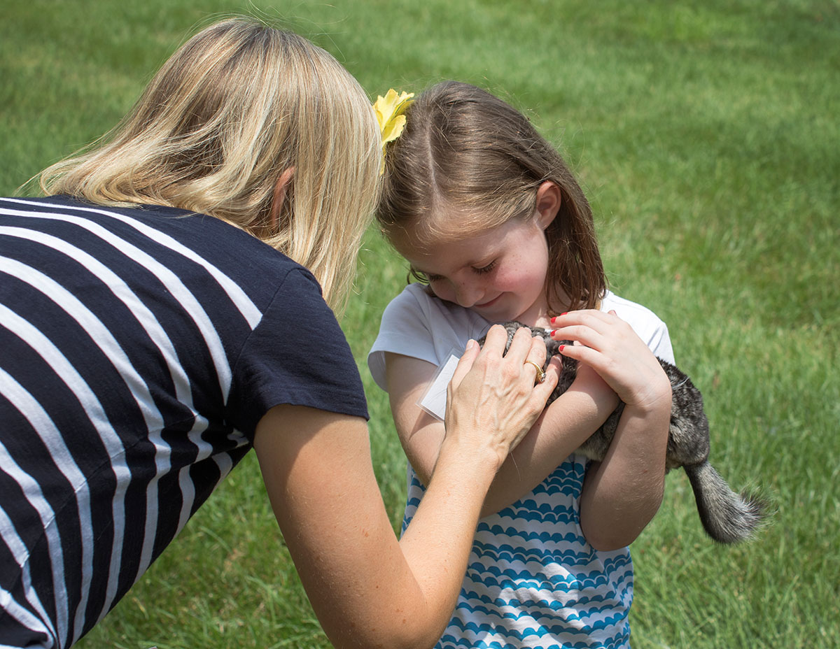 Claire holds a chinchilla, one of the animals brought by Zoodles, during Camp Explore Monday, July 6. (Photo by Emilie Milcarek)