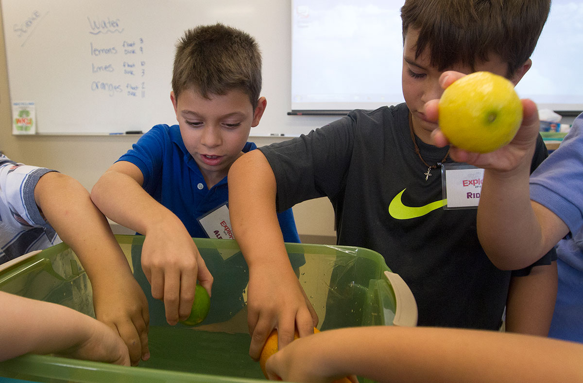 Camp Explore students test which fruits will float in Science Monday, July 6. (Photo by Sam Oldenburg)