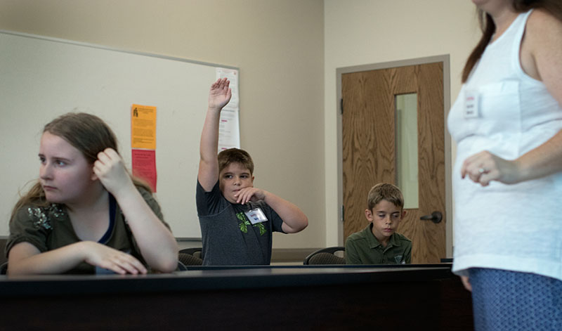 Whit raises his hand during Math at Camp Innovate on Tuesday, June 30. (Photo by Emilie Milcarek)