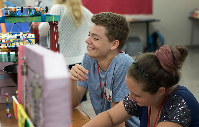 Eli Shelton (left) of Springfield, Tennessee, and teammate Rhianna Clemons of Elizabethtown laugh while working on their machines during STEAM Labs on Monday, June 29. (Photo by Emilie Milcarek)