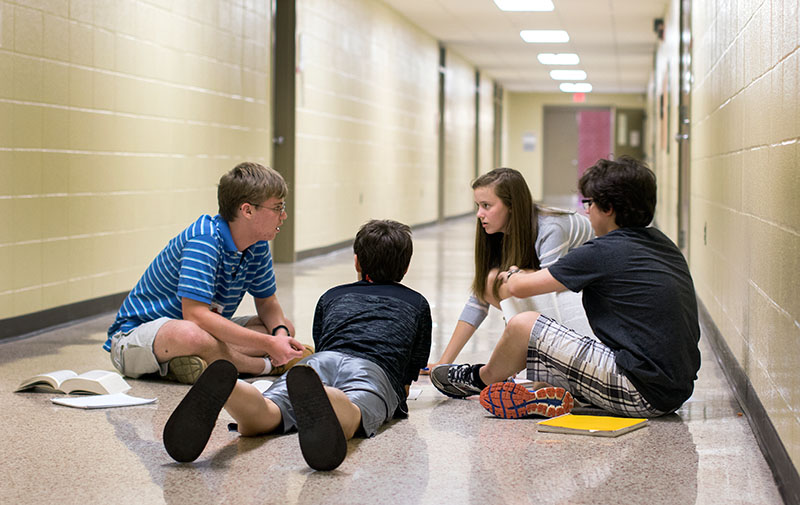Kendrick Foster (from left) of Houston, Texas, Baxter Fee of Bowling Green, Grace McMillin of Paris, and Hayden Teeter of Brentwood, Tennessee, strategize before their campaign speech during Presidential Politics on Monday, June 29. (Photo by Emilie Milcarek)