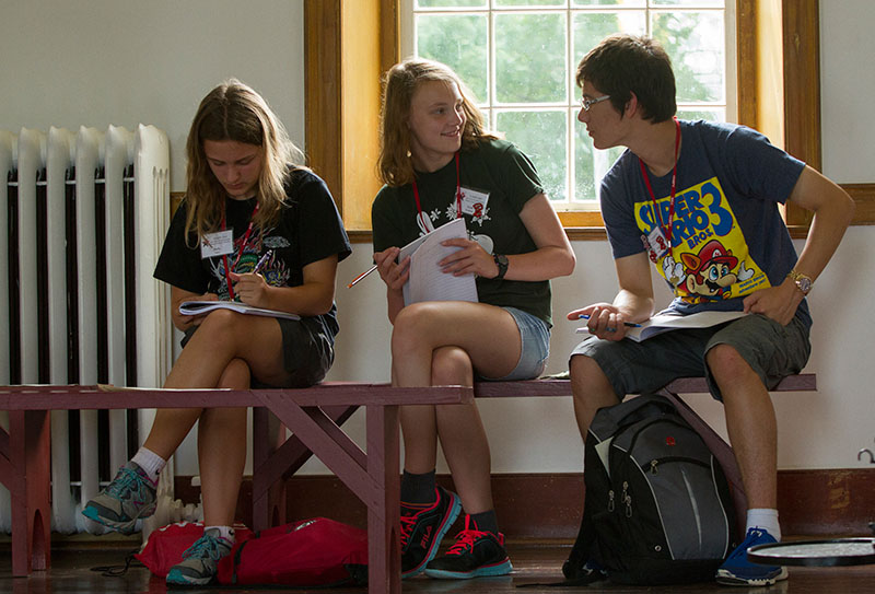 Holly Yelton (from left) and Kate Sweeney, both from Crestwood, and Isaac Huggins IV of Elizabethtown work on a writing activity during a field trip to the South Union Shaker Village with Writing Friday, July 3. (Photo by Sam Oldenburg)