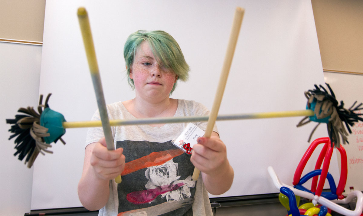 SCATS camper Evvie Cooley of Louisville practices tricks with devil's sticks during Clowning class June 10, 2015, at Western Kentucky University in Bowling Green.  (Photo by Sam Oldenburg)