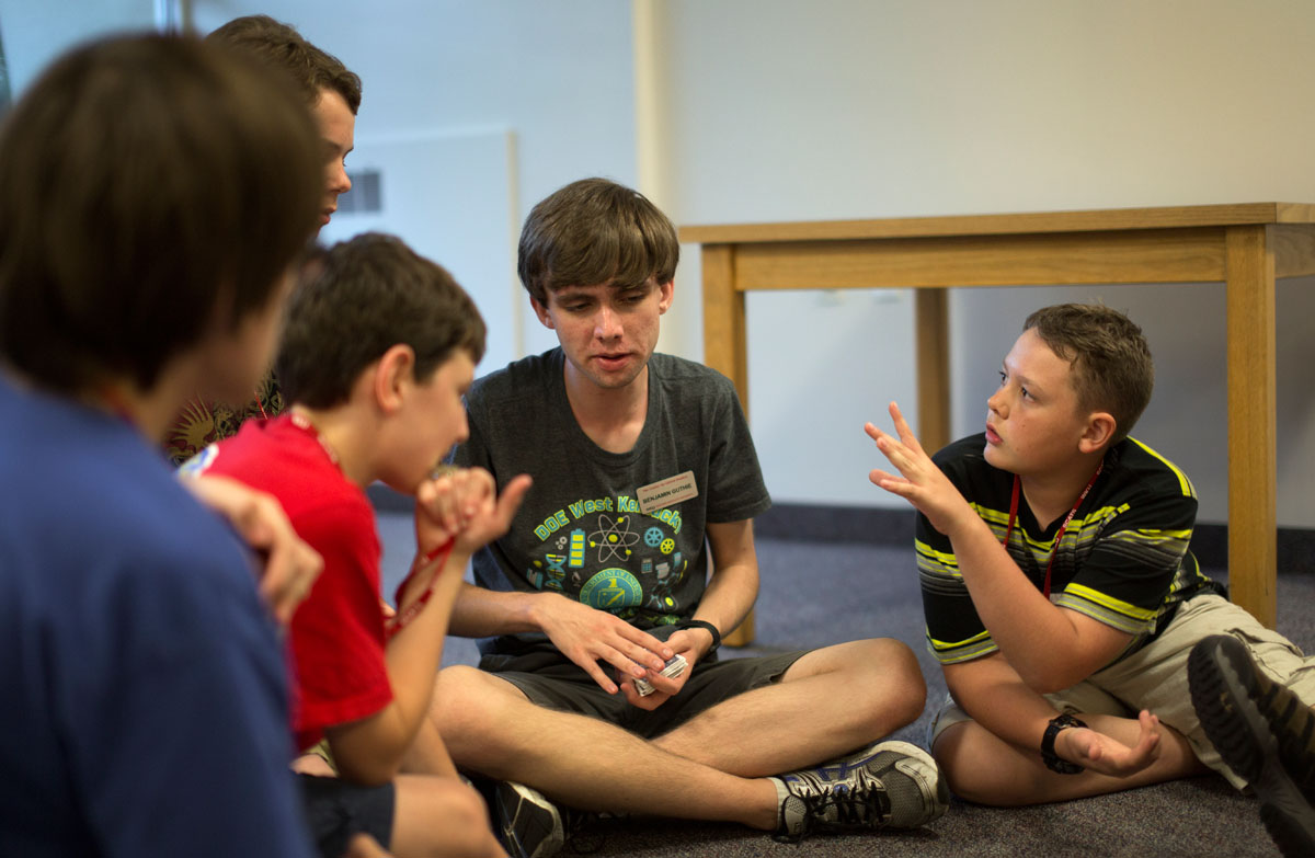 SCATS camper Cole LaDow of La Grange debates with counselor Ben Guthrie during a close game of Knights of the Round Table during optionals Tuesday, June 9. Ben ended the debate by starting a new round. (Photo by Emilie Milcarek)