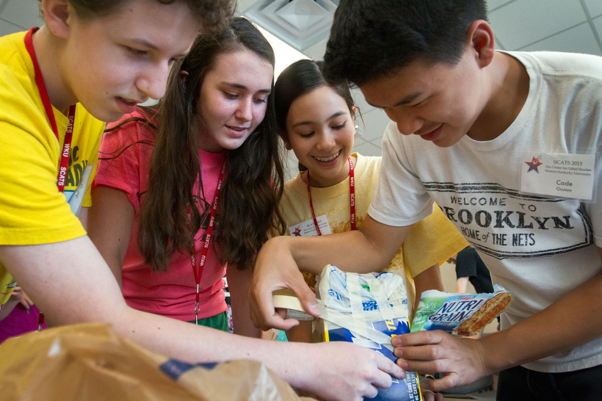 SCATS campers Patrick O'Boyle (from left) of Elizabethtown, Maddie Holl from The Plains, Ohio, Sarah Pedersen from Barbourville and Cade Oculam from Harrogate, Tenn., work on a container to use for an egg drop Friday, June 12, in Creative Problem Solving. The group's objective was to make a container that would keep an egg from breaking when dropped. (Photo by Sam Oldenburg)