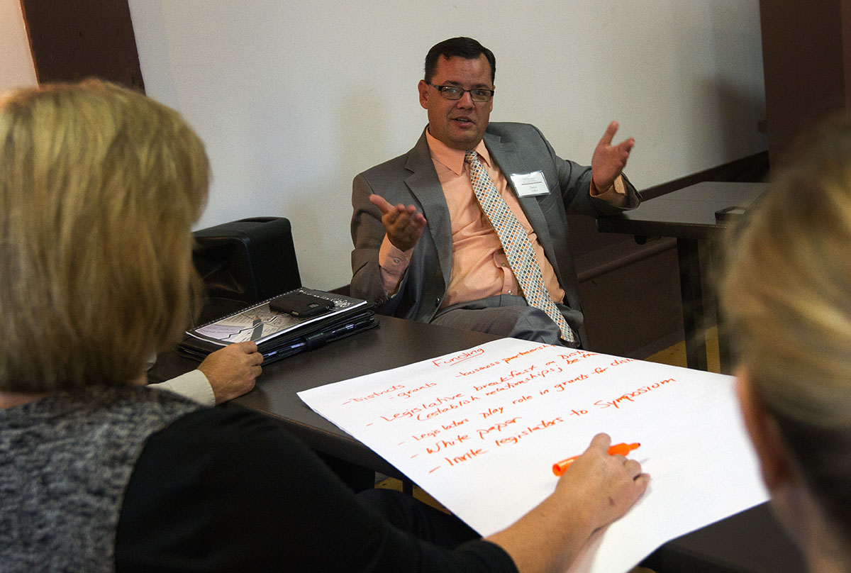 Fulton County Superintendent Aaron Collins brainstorms possible funding sources for gifted education with a group of Symposium attendees October 14.