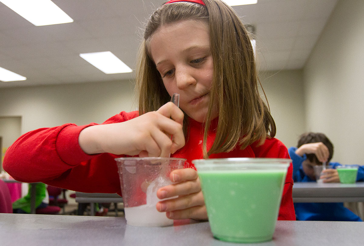Ainsley Stobaugh mixes borax and water that will be used to create a colored goo in Science Spectacular Saturdays.