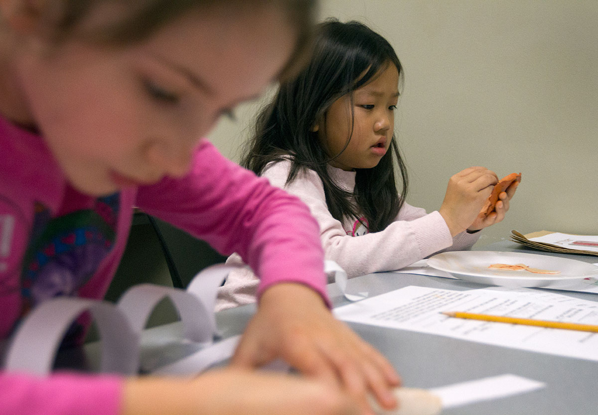 Kaylee Kessler (left) and Sheryl Sun make Roman coins out of clay during Time Travelers. The class "traveled through time" to learn about ancient Romans on the second Saturday of Winter Super Saturdays.