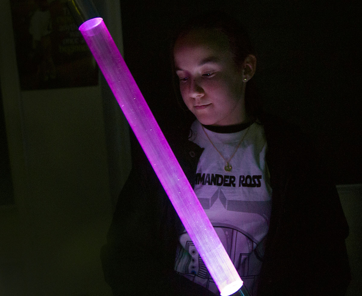 Skyla Ross examines her lightsaber to determine if more sanding is needed during May the Force Be With You.