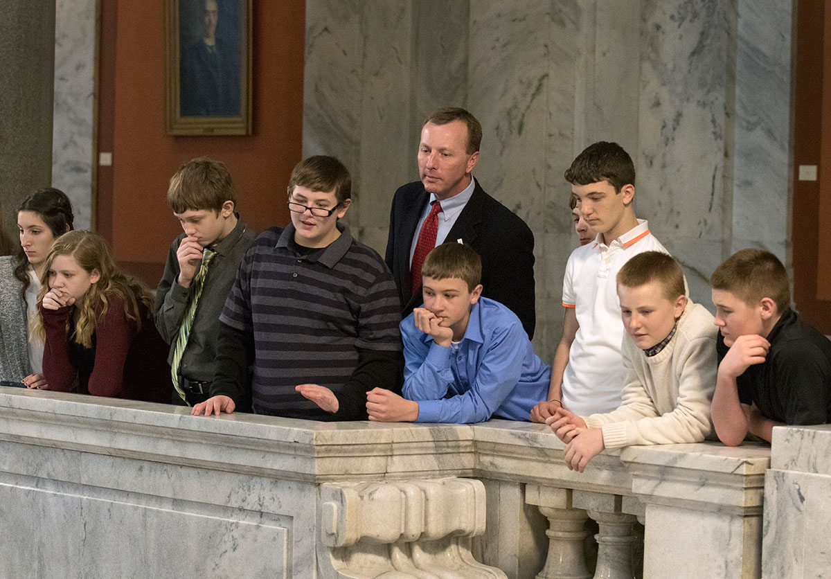 Bullitt County Schools Superintendent Keith Davis listens to speakers alongside students from his district during a ceremony celebrating Gifted Education Month in Kentucky February 3 at the State Capitol in Frankfort. Keith was named Administrator of the Year by the National Association for Gifted Education in 2015. Around 120 students from Bullitt County attended the ceremony.
