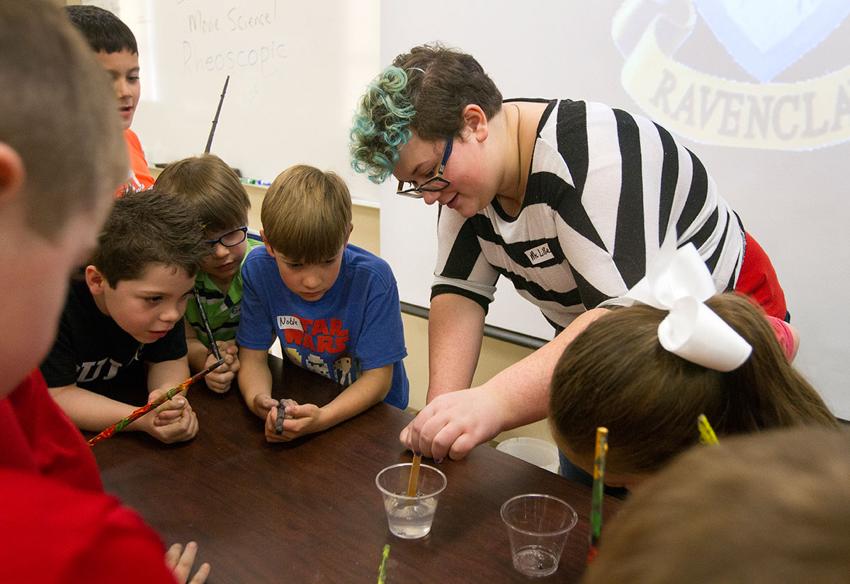 WKU freshman and VAMPY alumnus Lillie Shaw mixes a "potion" as students watch during Behind the Scenes Movie Magic.