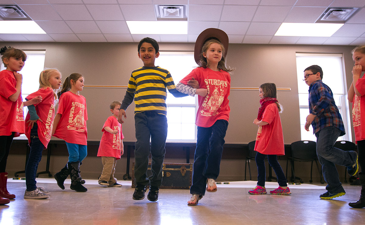 Avaneesh Nayak (left) and Reagen Girffiths rehearse for "Howdy Neighbor" during Intro to Musical Theatre: Let's Sing and Dance. The class was preparing to perform the musical for parents at the end of the final Saturday.