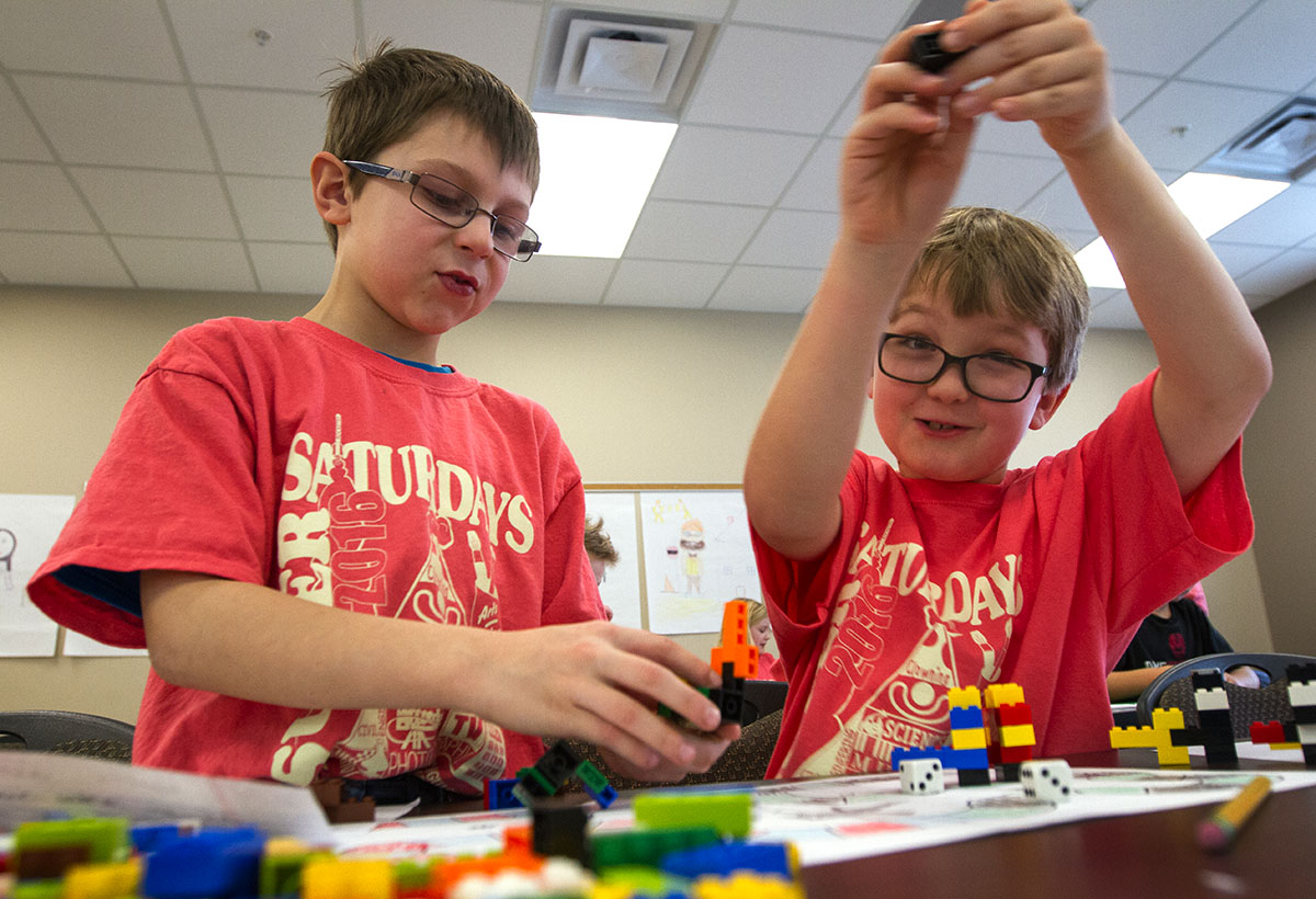 Wyatt Todd (left) plays a board game he created with a classmate in Learning with Legos. Wyatt's game was called Space Battles and Ground Battles.