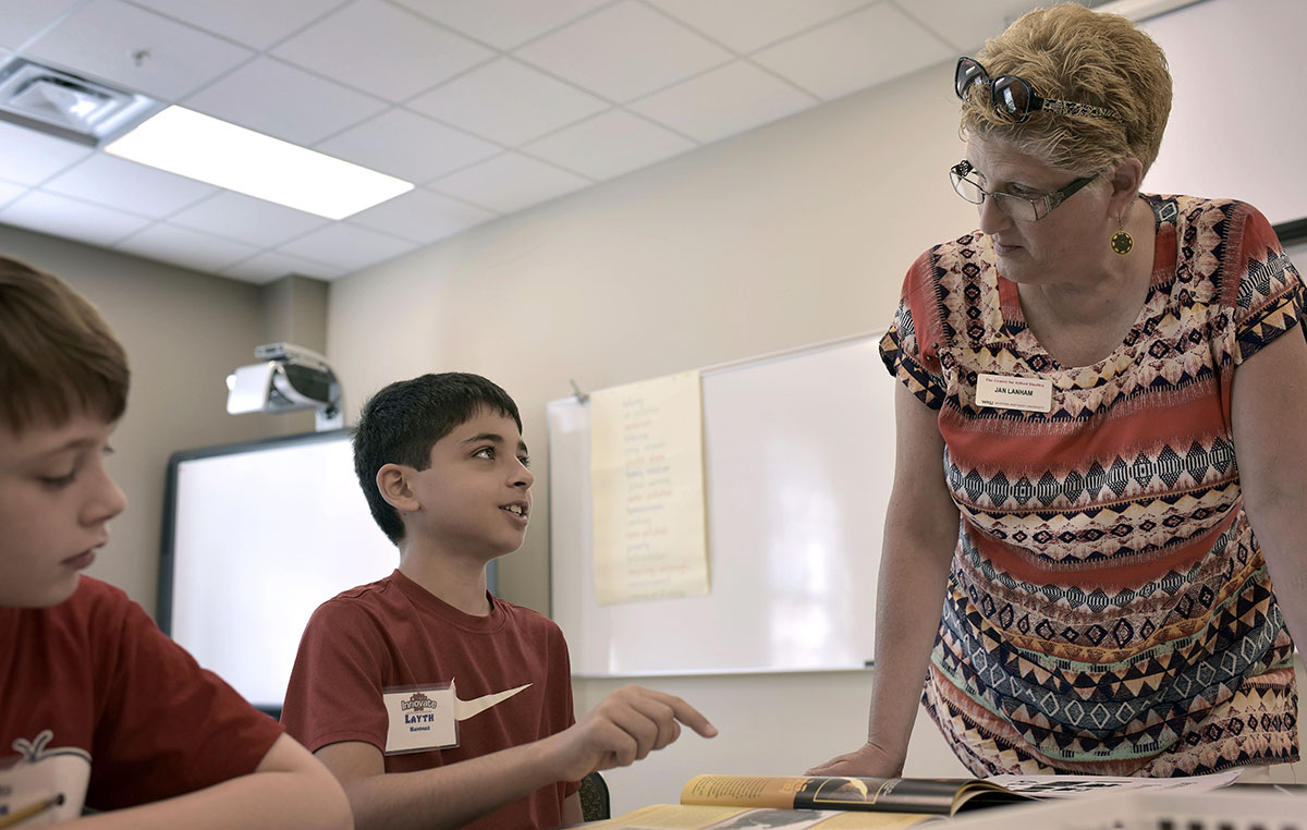 Layth Hammed works with Language Arts teacher Jan Lanham on an activity about the innovations and creativity of historic civilizations on Tuesday, June 7, during Camp Innovate. The purpose of this activity was to show the campers that they are capable of solving complex issues by thinking differently. (Photo by Tucker Allen Covey)