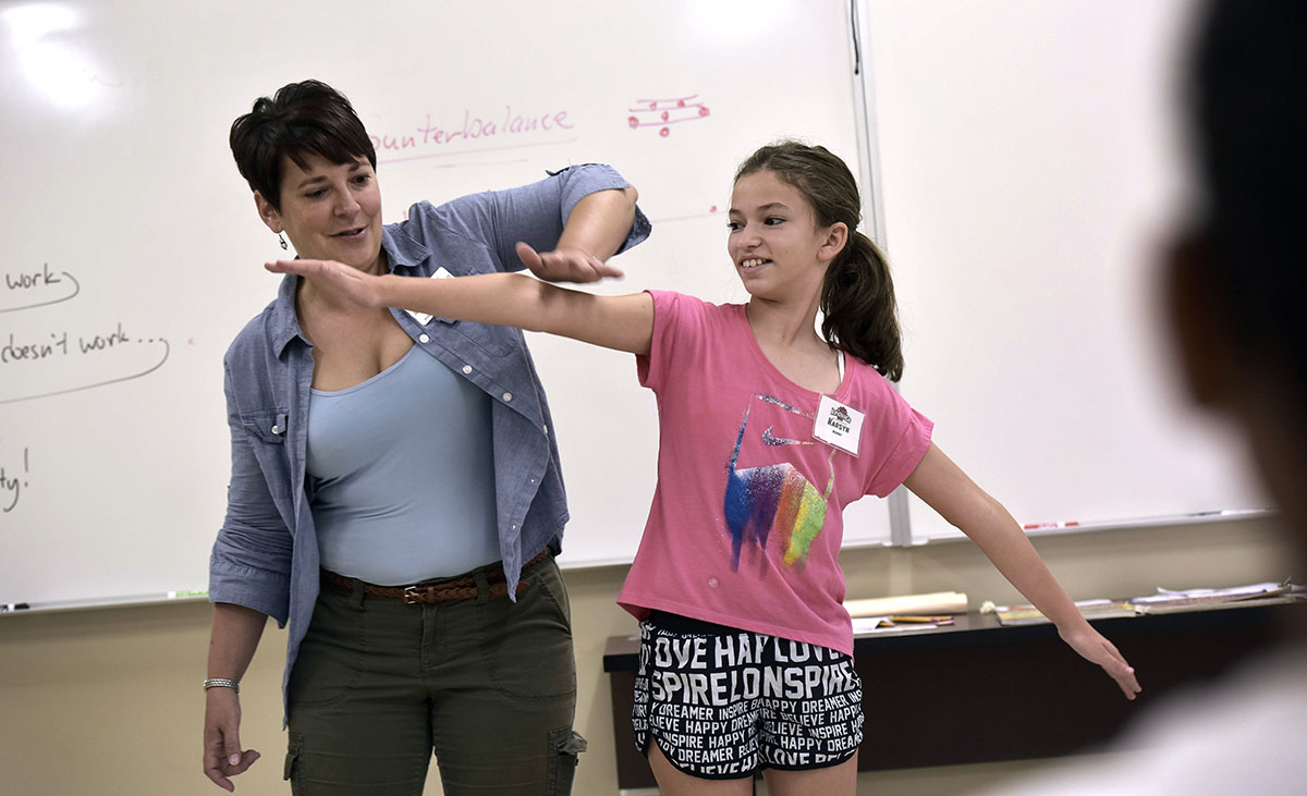 Science teacher Jennifer Sheffield shows camper Karsyn Ashby how weight distribution can affect the integrity of a cantilever on Tuesday, June 7, during Camp Innovate. Jennifer actively engages the students with activities to help them understand science topics. (Photo by Tucker Allen Covey)