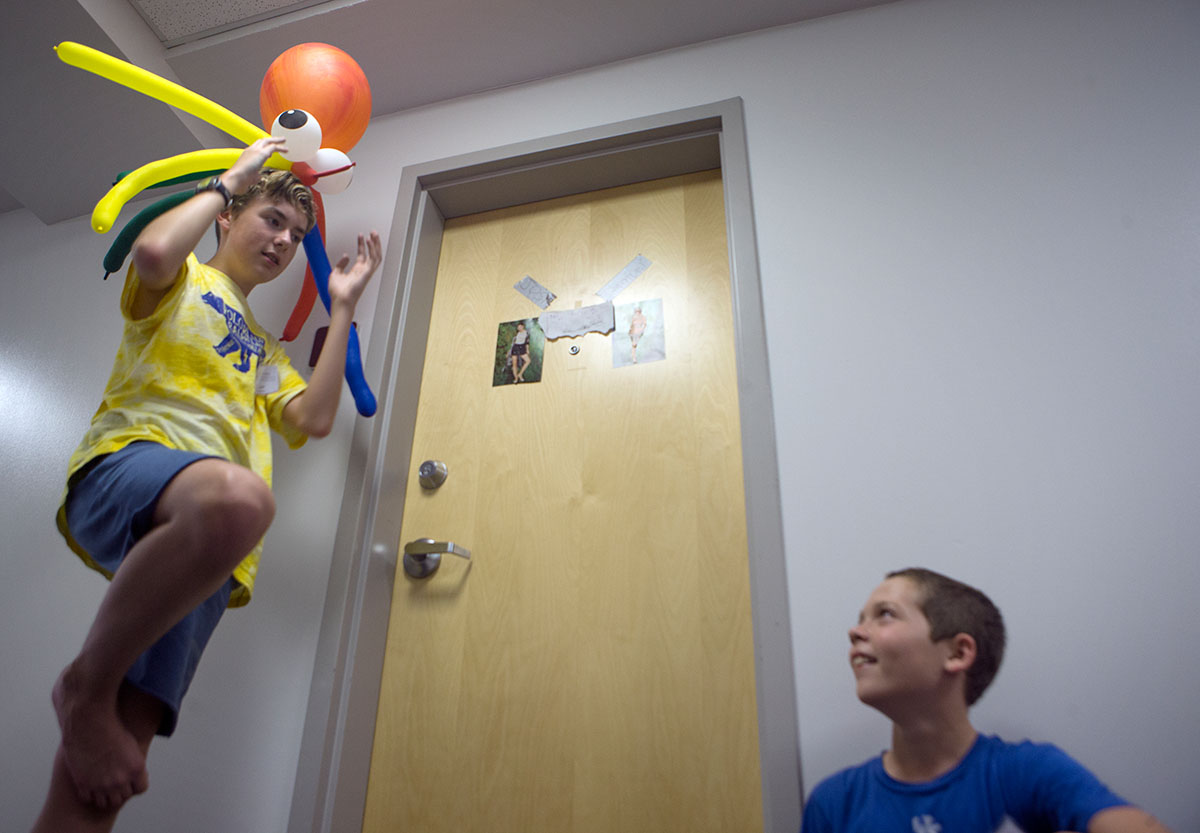 Josh Ciaburri (left) of Louisville shows his hallmate Quenten Morgan from Berea his new octopus balloon animal made in Clowning class Tuesday, June 14. (Photo by Tucker Allen Covey)