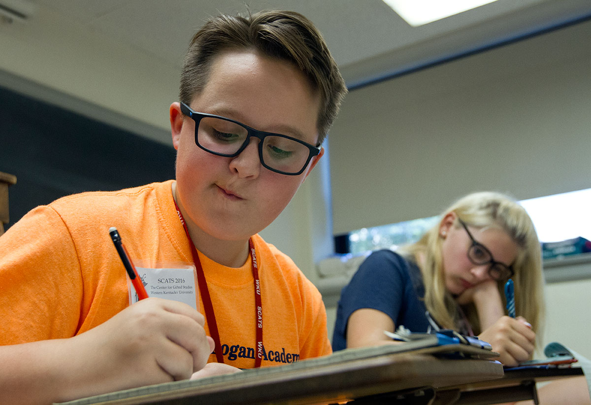 Calloway Bills of Russellville works on his story during Writing Boot Camp Thursday, June 16. (Photo by Sam Oldenburg)