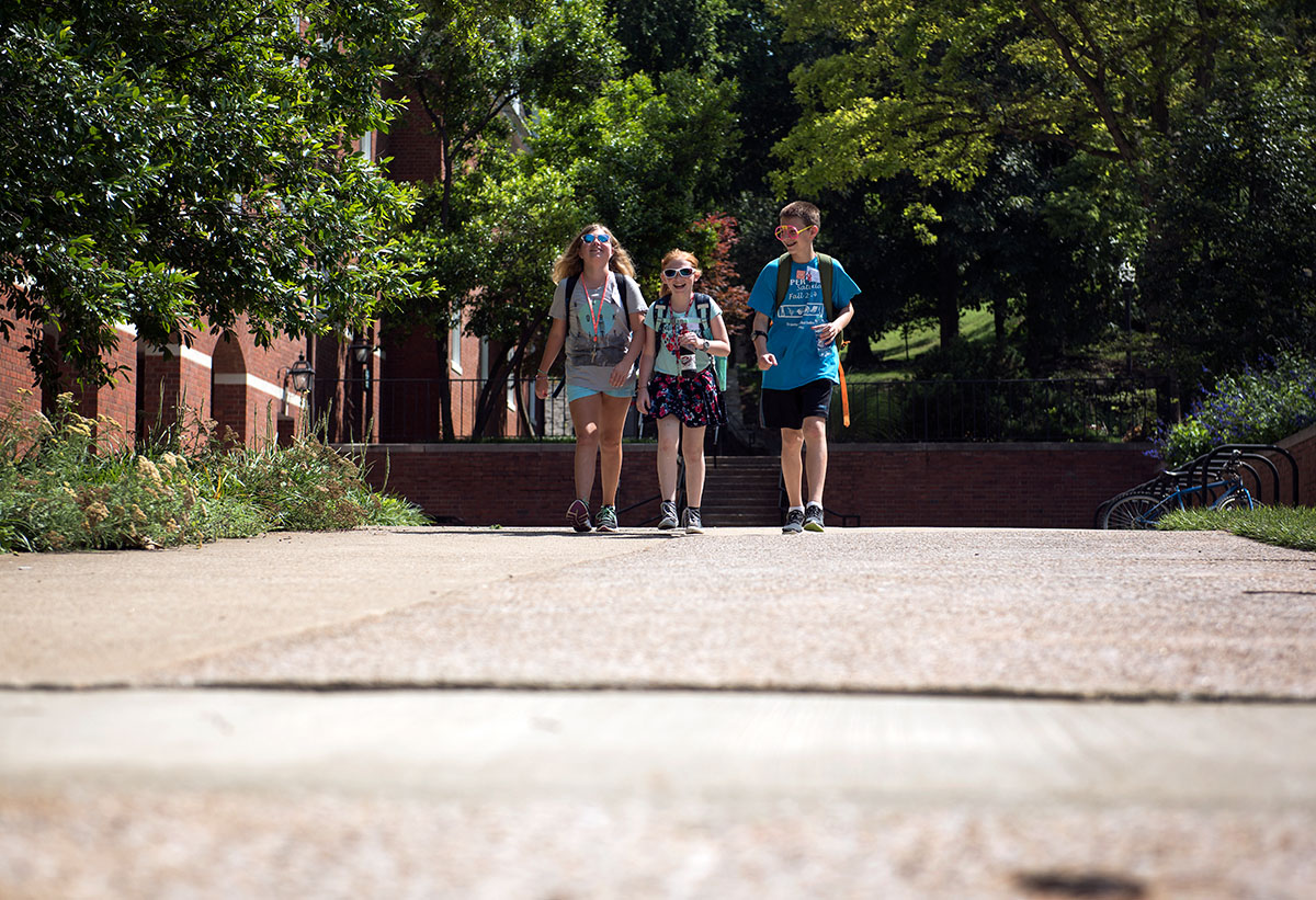 Samantha Bailey (from left) of Villa Hills, C.J. Johnston of Leitchfield, and Isaac Bunch of Bowling Green walk down the hill together to get to their second period classes Thursday, June 16. (Photo by Tucker Allen Covey)
