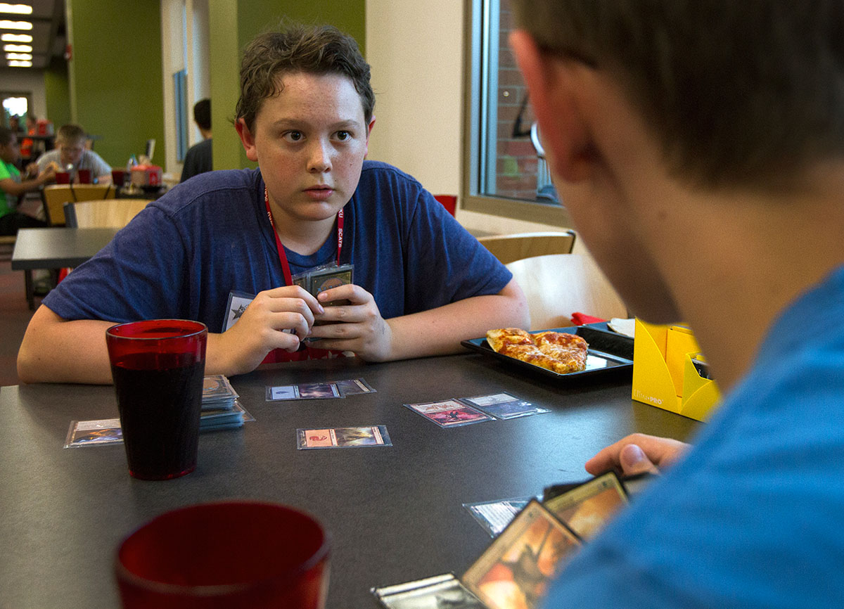 Cole LaDow (left) of La Grange plays Magic the Gathering with Samuel McGuire of Boonville, Indiana, after finishing dinner at Fresh Food Company in Downing Student Union Thursday, June 16. (Photo by Sam Oldenburg)