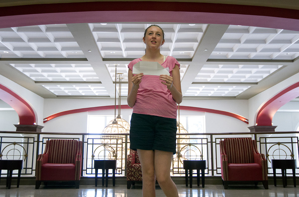 Hannah Gill of Morgantown prepares to test her paper airplane during Creative Problem Solving Monday, June 13, in the Honors College and International Center. (Photo by Sam Oldenburg)