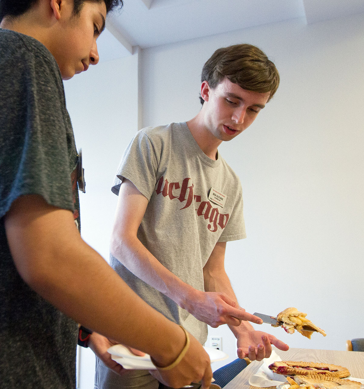 Counselor Ben Guthrie serves pie to a camper during the Tau is Greater Than Pi optional Tuesday, June 28. (Photo by Sam Oldenburg)