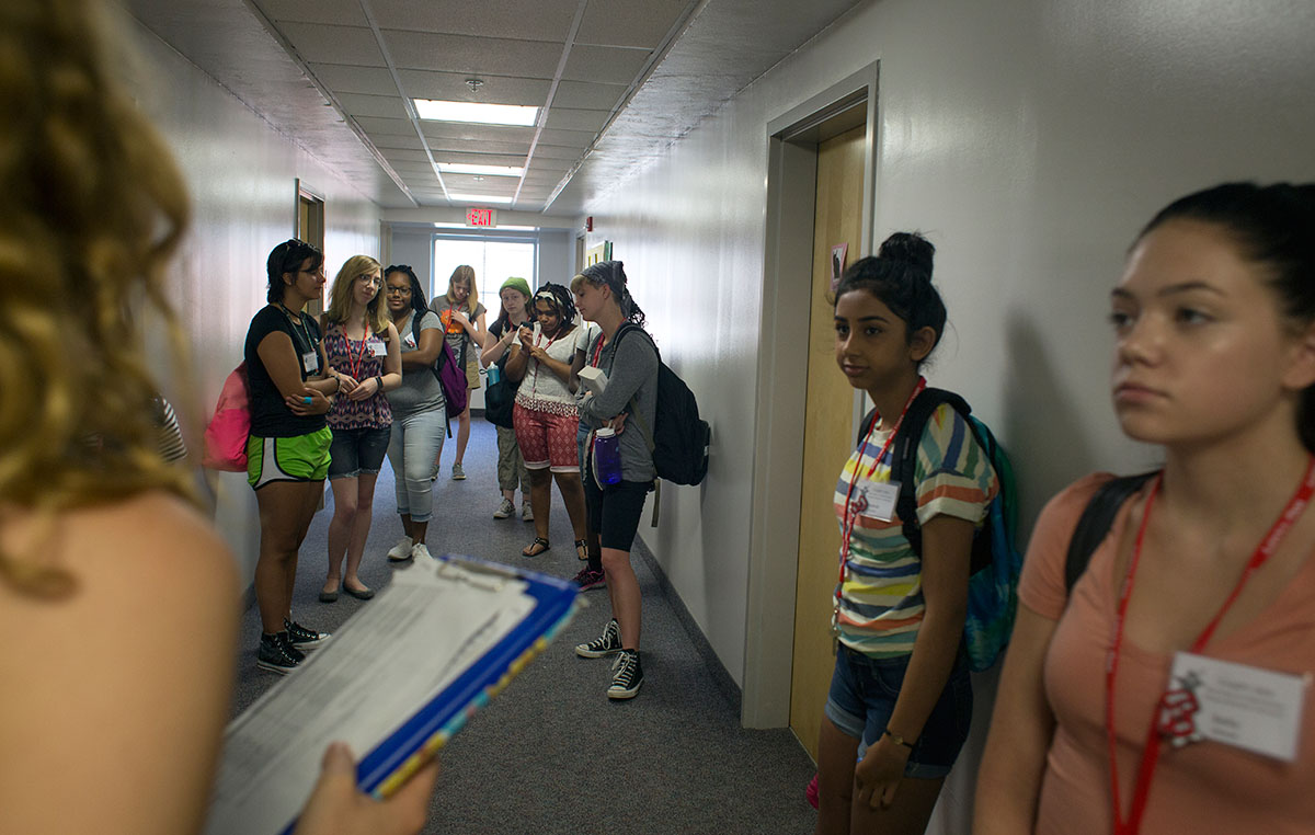Members of Ellie Hogg's group ready themselves in the morning outside their rooms before heading to breakfast and class Monday, June 27. (Photo by Tucker Allen Covey)