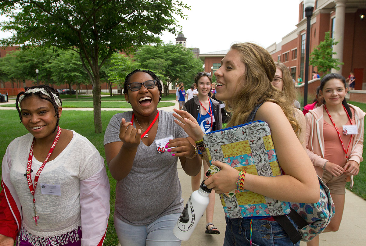 Ali Shackelford (from left) of Louisville, To'Nia Beavers of Bowling Green, and counselor Ellie Hogg laugh about something that happened during dinner while walking back to Northeast Hall after eating. (Photo by Sam Oldenburg)