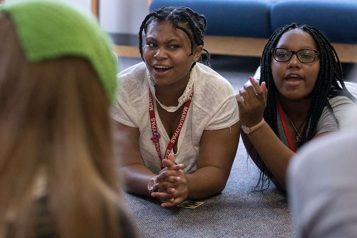 Ali Shackelford (left) of Louisville and To'Nia Beavers of Bowling Green play Werewolf with other campers during Mandatory Optionals Monday, June 27. It's mandatory that campers sign up for one activity in the evening, but optional which activity they choose. (Photo by Sam Oldenburg)