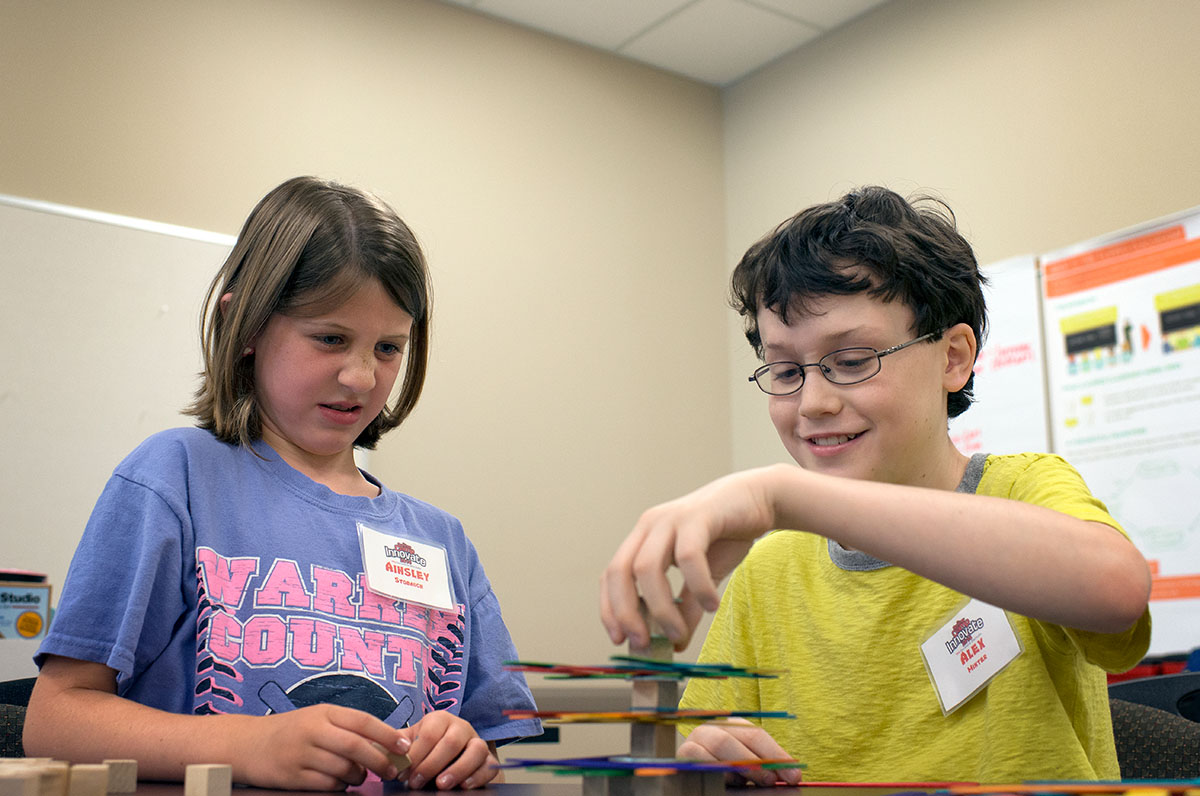 Ainsley Stomach (left) and Alex Minter build a counterbalanced tower during Science at Camp Innovate Monday, June 6. (Photo by Tucker Covey)