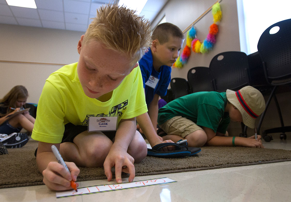 Cade Howell makes a name tag with his favorite number during Math at Camp Innovate on Monday, June 6. (Photo by Sam Oldenburg)